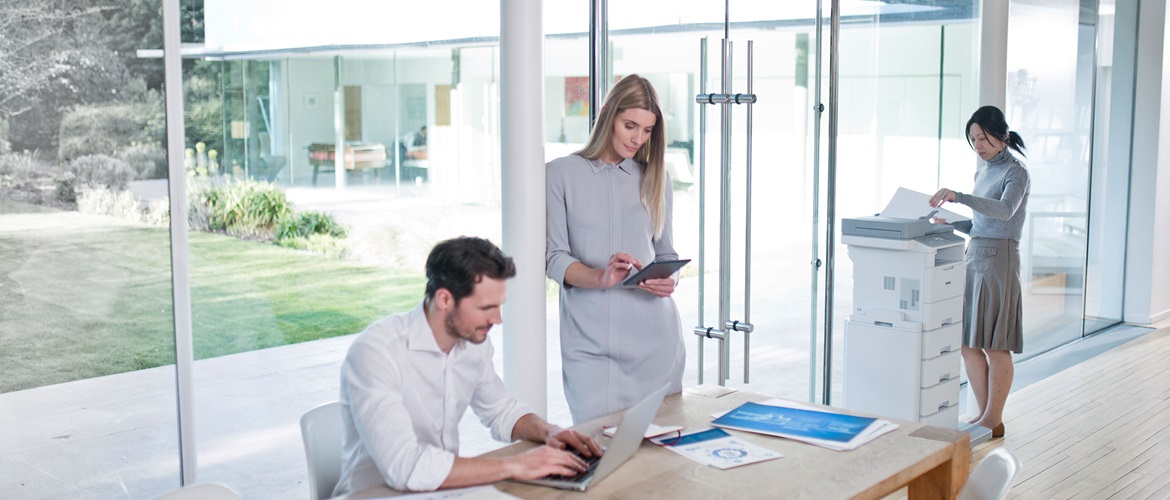 Three colleagues use Brother mono-laser printer in office